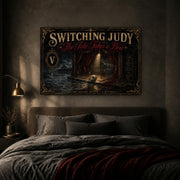 The Tide Takes a Bow landscape canvas depicting an empty seaside stage and discarded mask, shown in a moody bedroom above a bed.